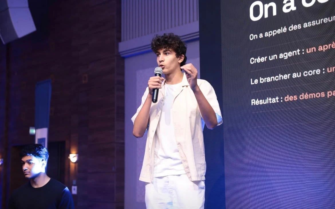 Khalil Eltaief on stage, holding a microphone.
